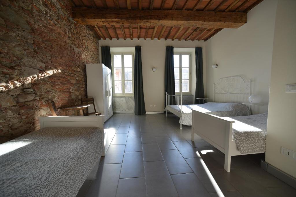 Postel nebo postele na pokoji v ubytování Ostello Palazzo Nizza