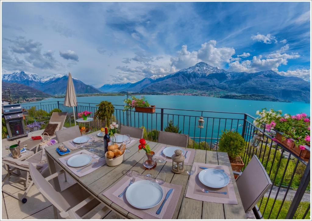 a table on a balcony with a view of a lake at Villa Aquarius - Larihome A08 in Vercana