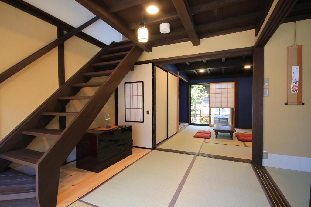 a living room with a staircase in a house at Kanazawa Bettei Yuan in Kanazawa