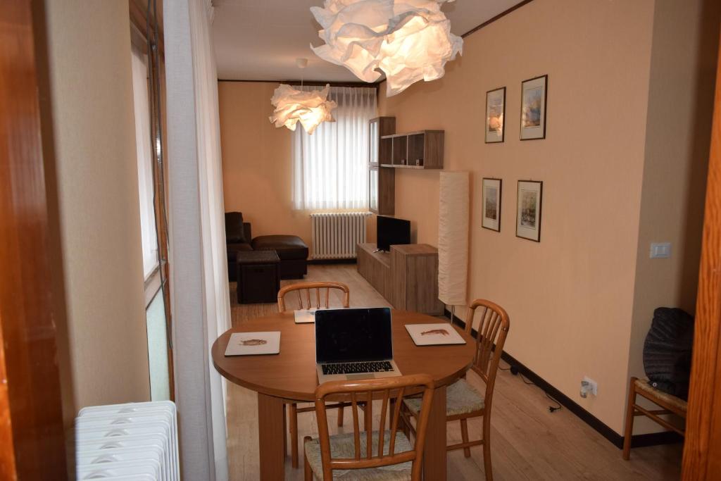 uma sala de estar com uma mesa com um computador portátil em Lozzo di Cadore - Dolomiti - Piazza IV novembre em Lozzo Cadore