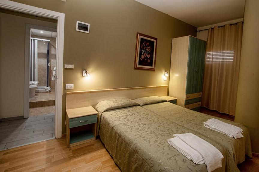 Postel nebo postele na pokoji v ubytování Hotel Scacciapensieri