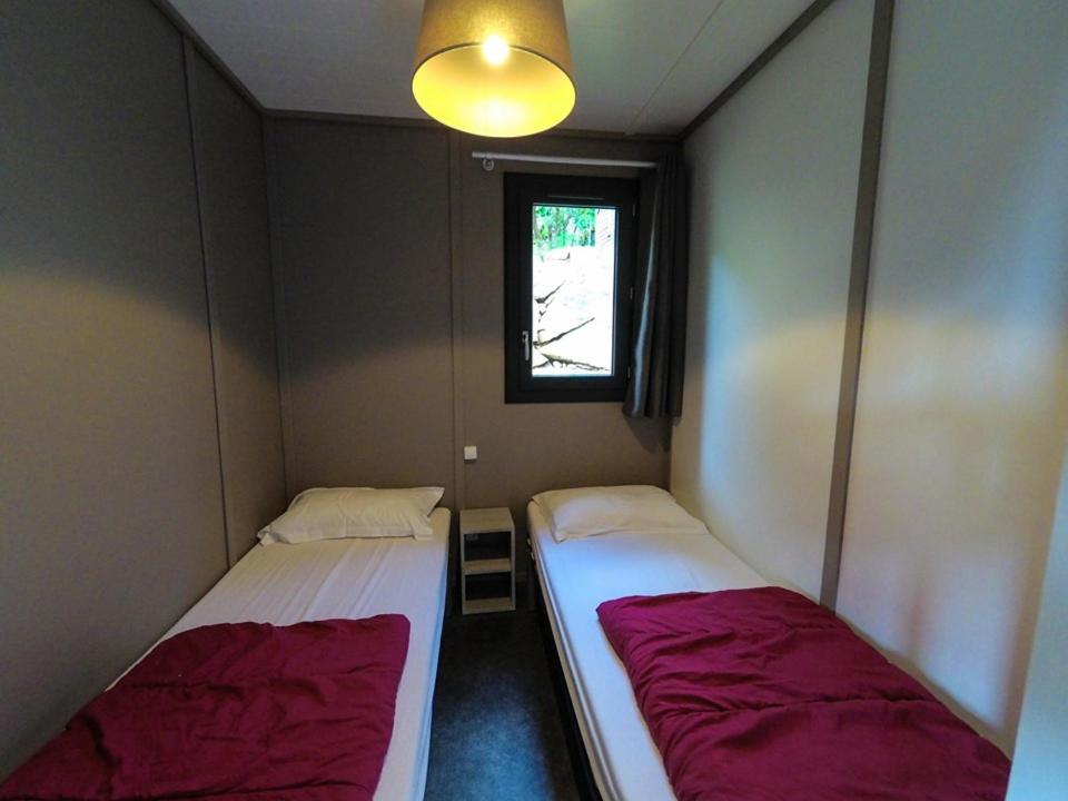 Postel nebo postele na pokoji v ubytování Camping Les Oliviers