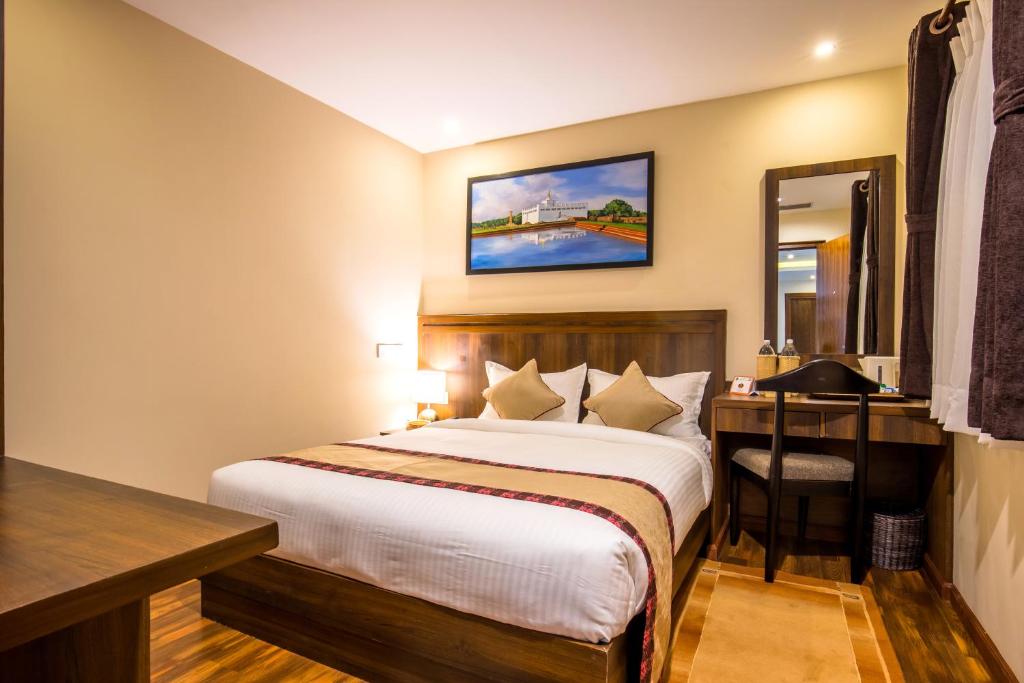 Postel nebo postele na pokoji v ubytování Hotel Kutumba