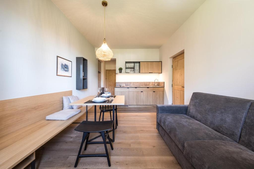 a living room with a couch and a table at Landhaus Lina in Caldaro