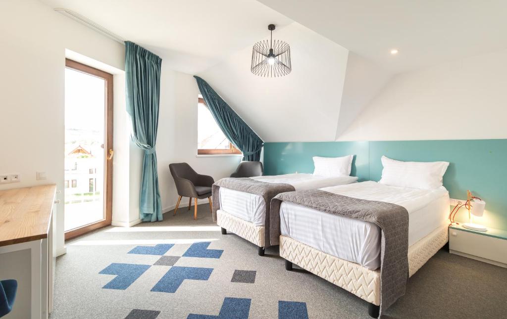 two beds in a room with blue and white at Horeum Boutique Hotel in Sibiu
