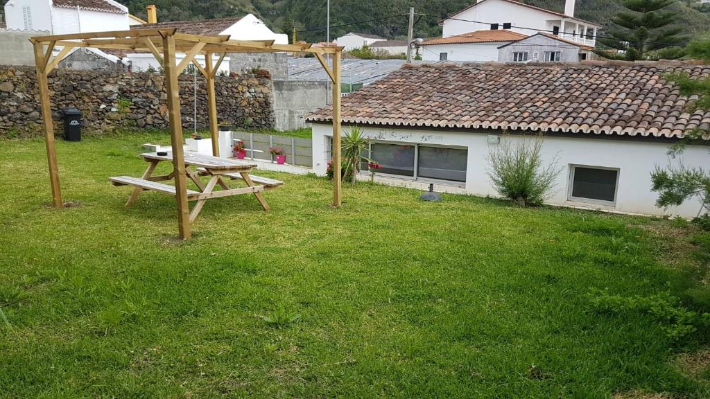 a picnic table in the yard of a house at Our relaxing holiday home in Mosteiros