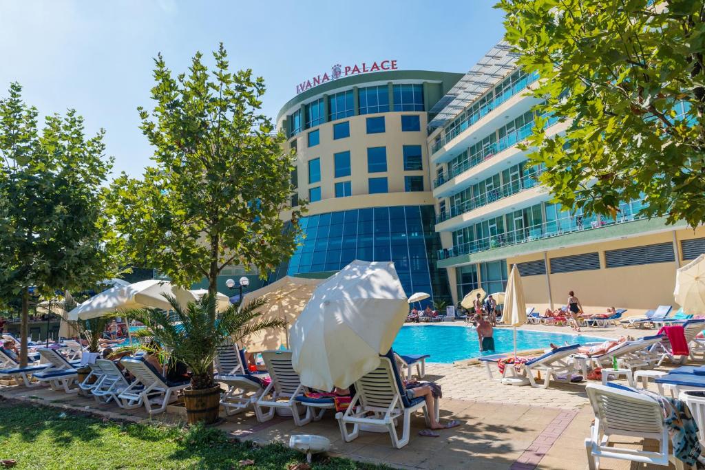 a swimming pool with lounge chairs and a hotel at Ivana Palace Hotel - Free Parking in Sunny Beach