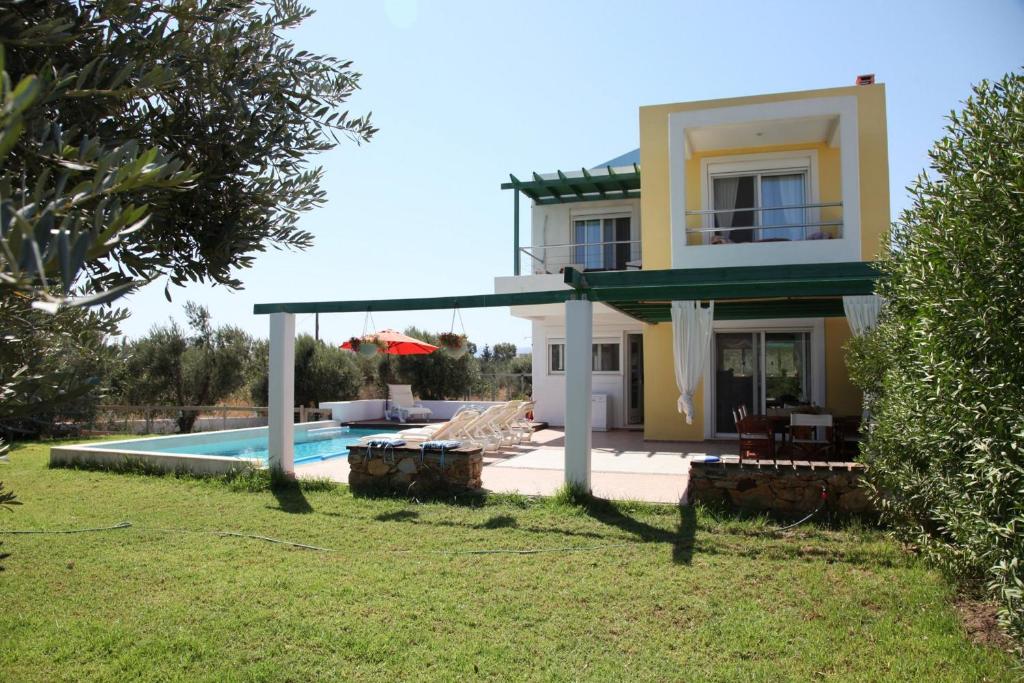 a villa with a swimming pool and a house at TEO-VILLA-1, private pool, sea and golf in Afantou