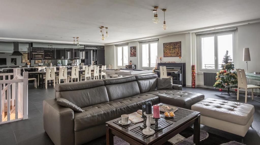 a living room with a couch and a table at Le Notre Dame - Luxury Apartment with Seine View in Paris