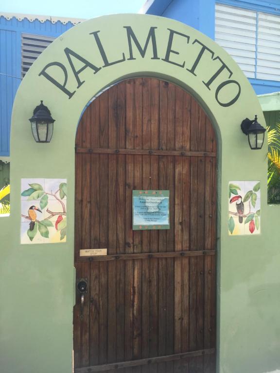 a wooden door with a sign that reads salamino at Palmetto Guesthouse in Culebra