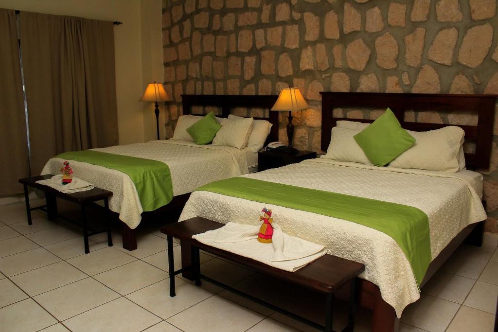 Postel nebo postele na pokoji v ubytování Plaza Magdalena Hotel