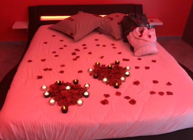 a bed with lots of hearts on it at dampierrelove in Dampierre-les-Bois