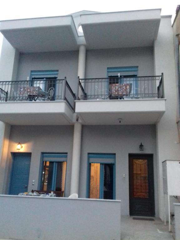 - un bâtiment avec 2 balcons au-dessus dans l'établissement KOSTAS FAMILY ROOMS, à Stavros