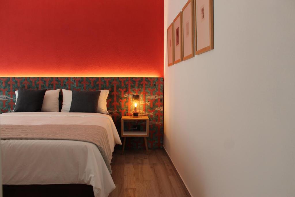 a bedroom with two beds and a red wall at Calma di vento in Sestri Levante