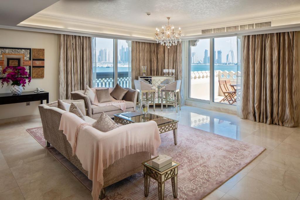 a living room with a couch and a table at Luton Vacation Homes - Full Sea View & Huge 2BR , Grandeur Residences, Palm Jumeirah-MC40AB3 in Dubai