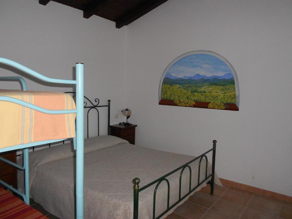 a bedroom with a bunk bed with a window at Agriturismo Su Birde in Orosei