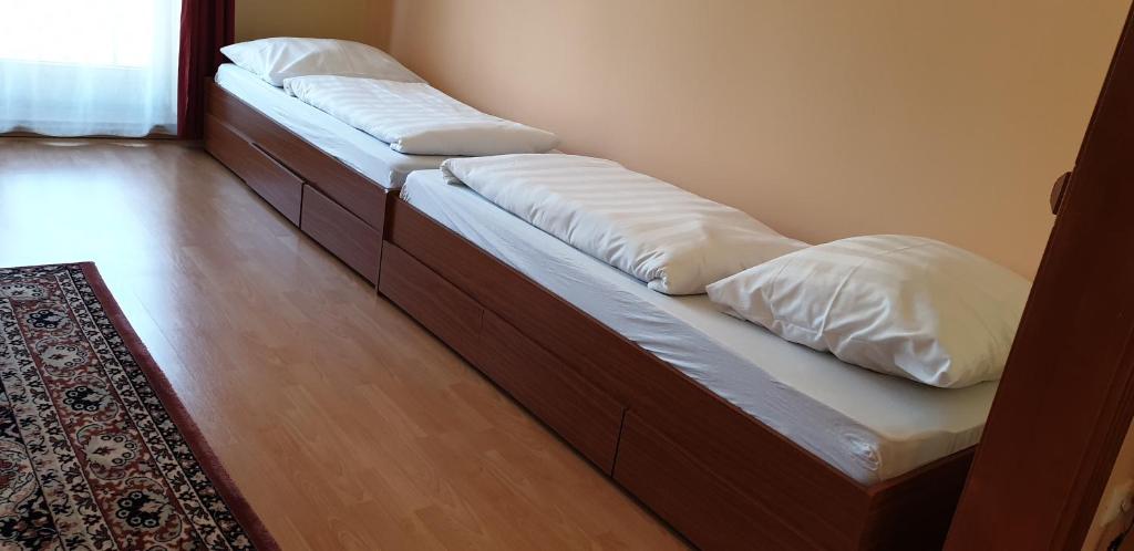 A bed or beds in a room at Penzion Montana