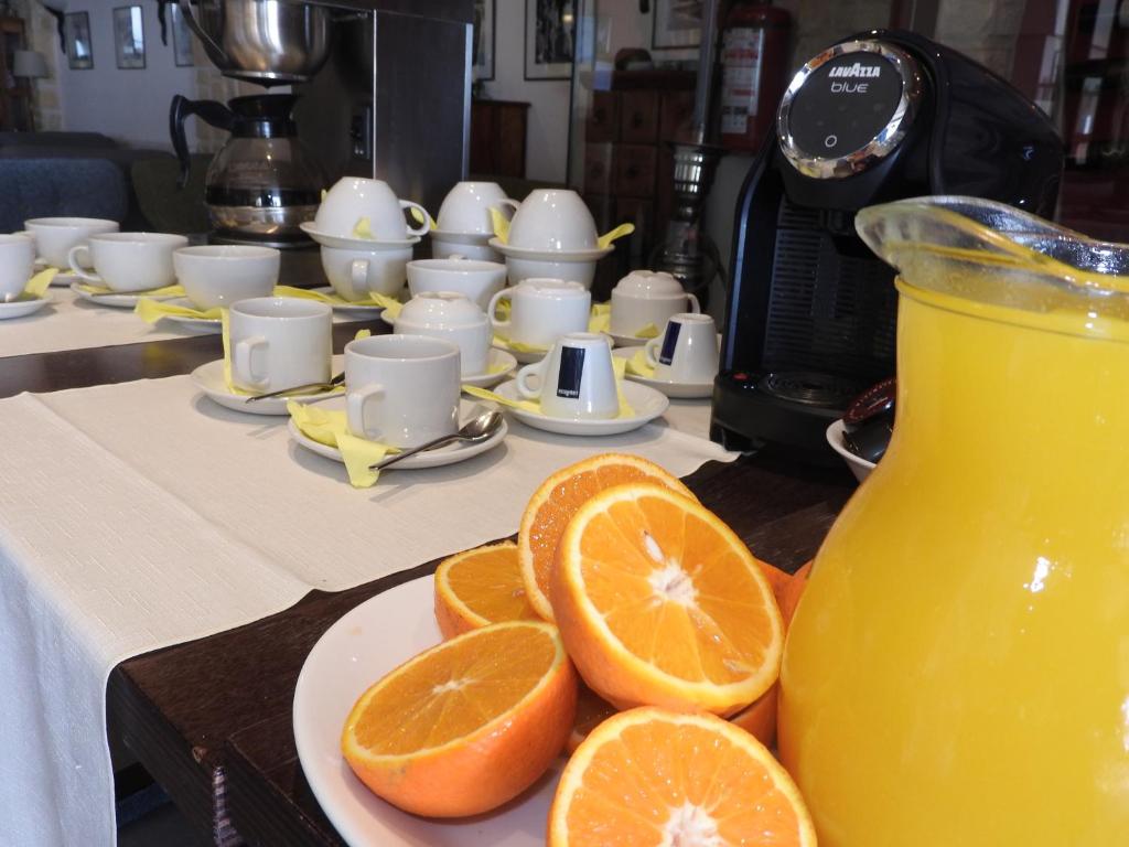 a plate of oranges and a jug of orange juice at Hill View Hotel Apartments in Pissouri