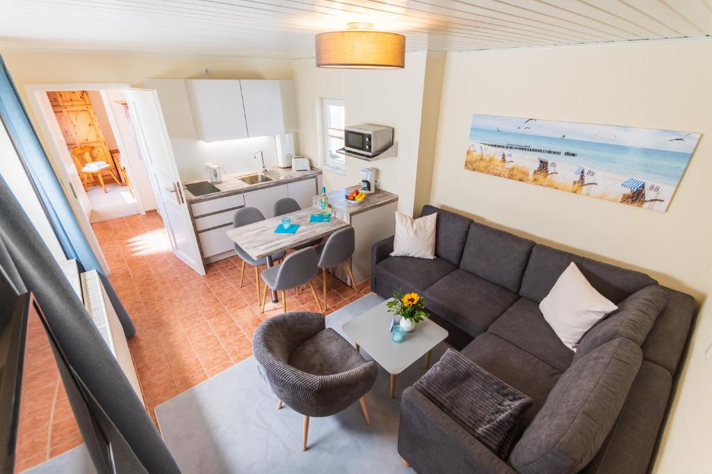 a living room with a couch and a table at Ferienbungalow Fischerstrand in Binz