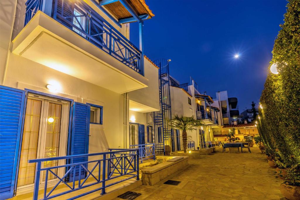 a city street at night with blue and white buildings at BBQ-Balcony-42Mbps-King-Backyard-Full Kitchen-2 in Amoudara Herakliou