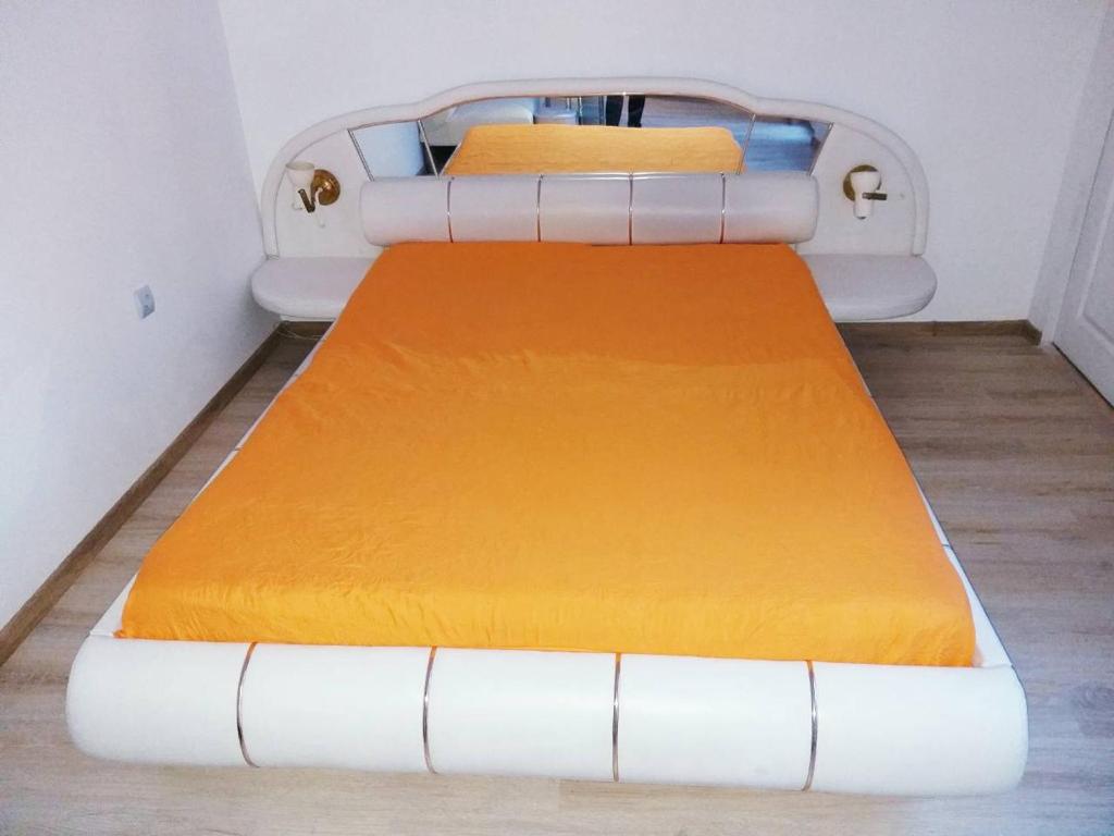 a hospital bed with an orange mattress in a room at STUDIO SUNRISE in Varna City