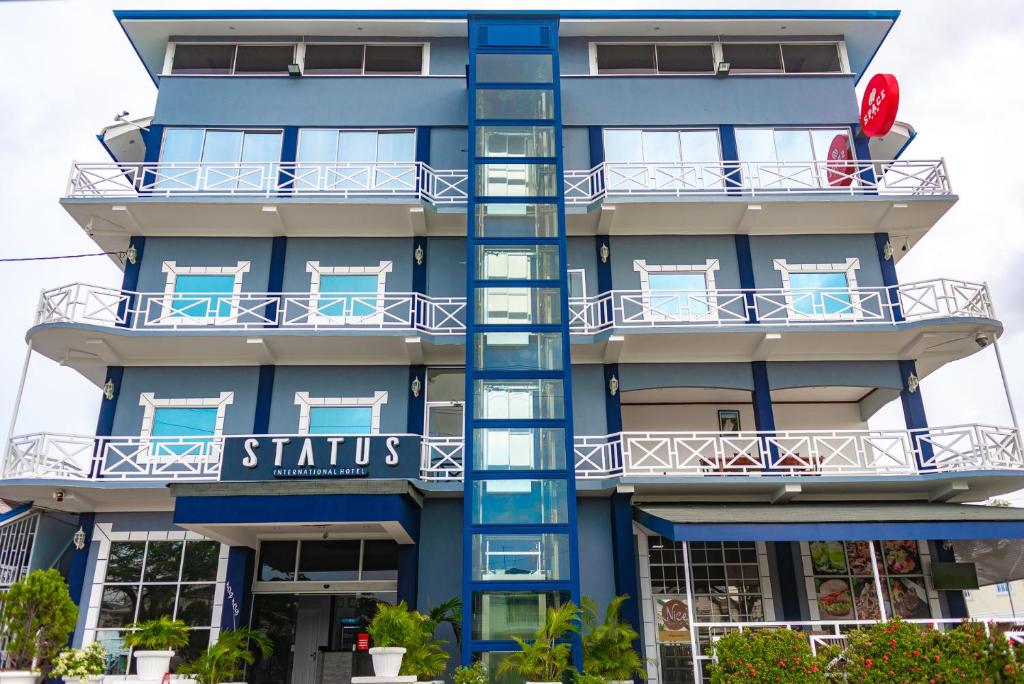 a blue and white building with a blue sky at Status International Hotel in Georgetown