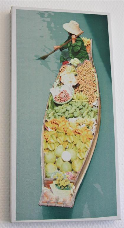 a picture of a woman in a boat filled with food at Clos Chantegrive in Saint-Médard-en-Jalles