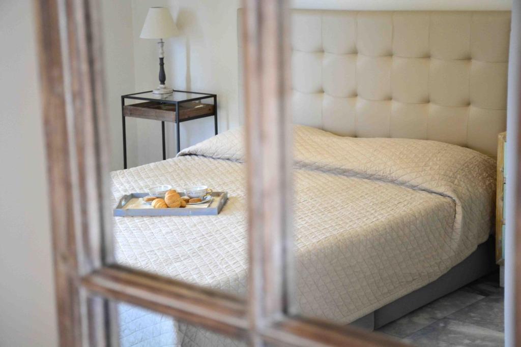 a mirror reflection of a bed with a tray on it at Aelia Houses in Agia Marina Aegina