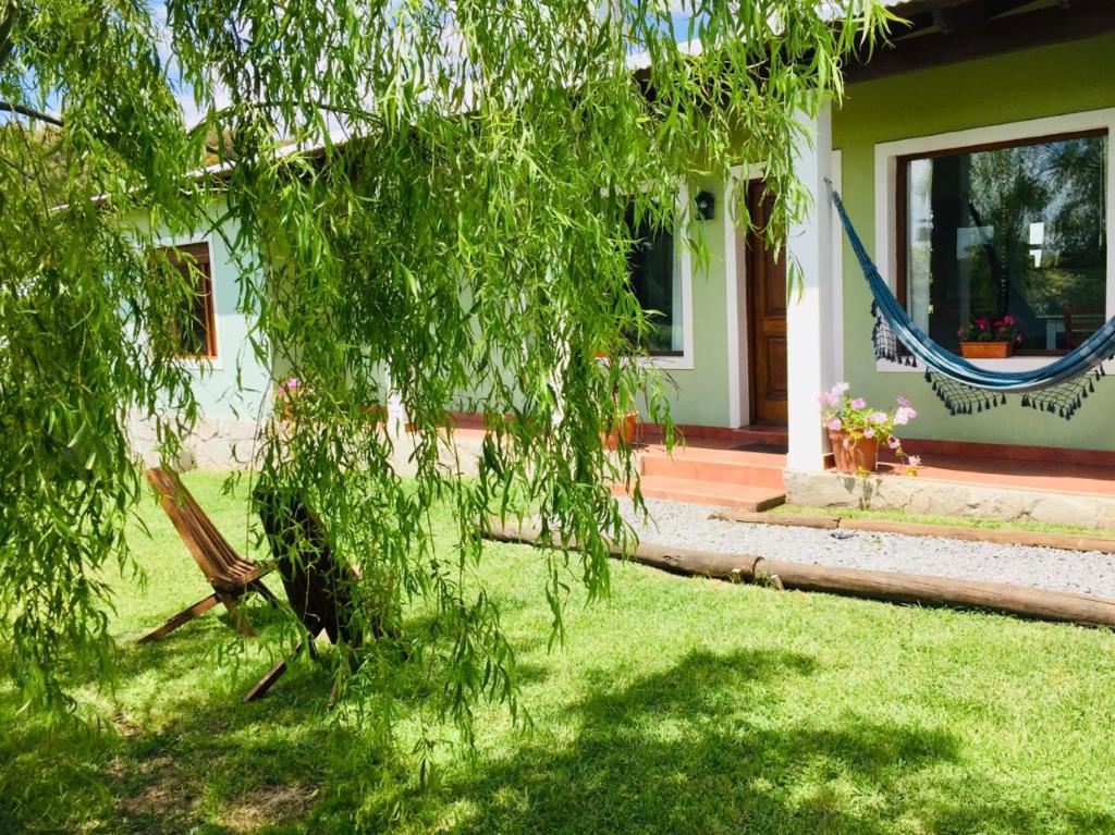 una casa con una hamaca frente a un patio en Luna Bonita en Tandil