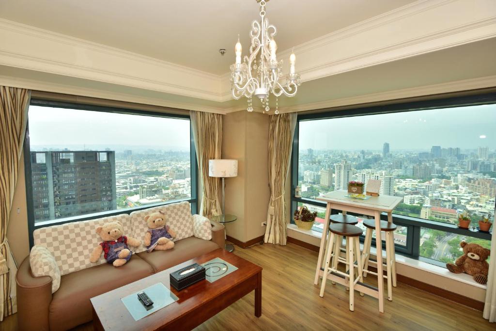 a living room with a couch and large windows at Luxury House in Taichung