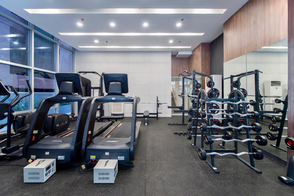 a gym with treadmills and elliptical machines at The Sphere Serviced Residences Managed by HII in Manila