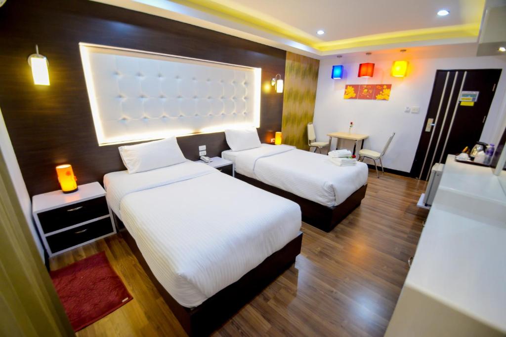 Кровать или кровати в номере โรงแรมลลิตา บูติค