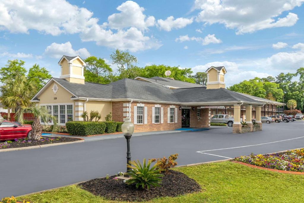 a house with a parking lot in front of it at Quality Inn & Suites in Lexington