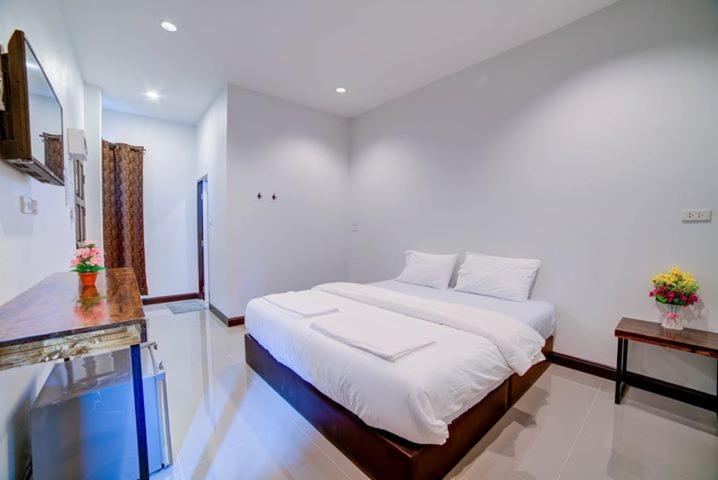 a bedroom with a large bed in a room at The Sleep Resort in Chiang Mai