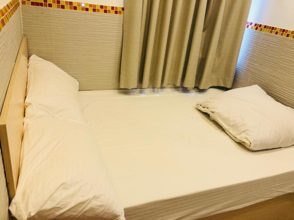 Postel nebo postele na pokoji v ubytování Chung Kiu Come Inn