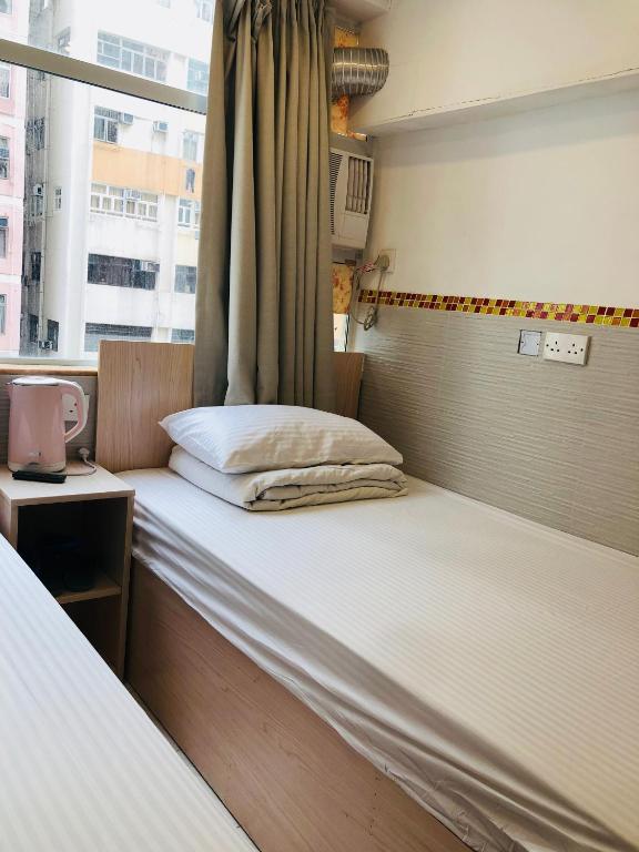 Postel nebo postele na pokoji v ubytování Chung Kiu Come Inn
