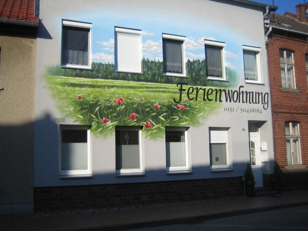 um edifício com uma pintura de flores sobre ele em Ferienwohnungen Marita em Salzwedel