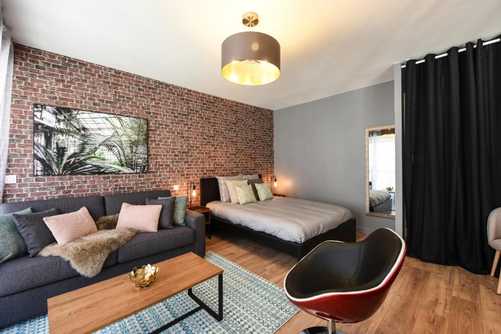 a living room with a couch and a bed at Nice and modern studio in the heart of Annecy in Annecy