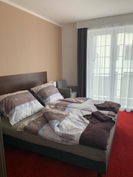 Postel nebo postele na pokoji v ubytování Wellness hotel Harmonie Třeboň