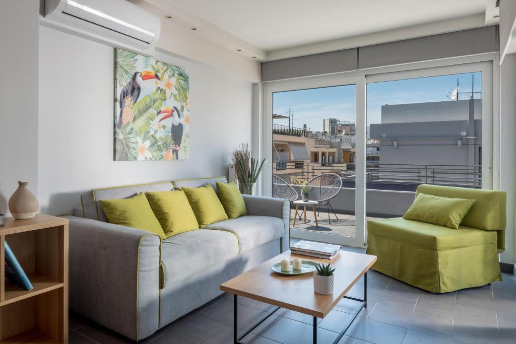 a living room with a couch and a table at 12 Keys Athens Apartments in Athens