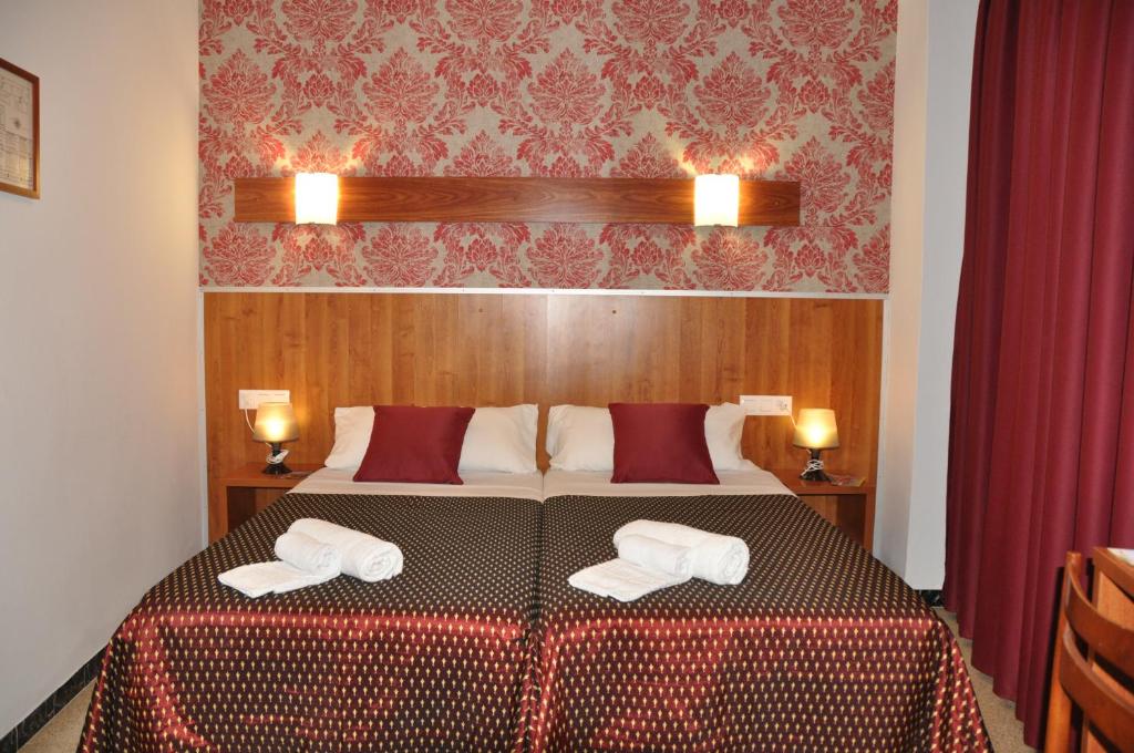 Postel nebo postele na pokoji v ubytování Hostal - Pensión El Amigo