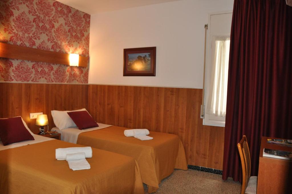 Postel nebo postele na pokoji v ubytování Hostal - Pensión El Amigo