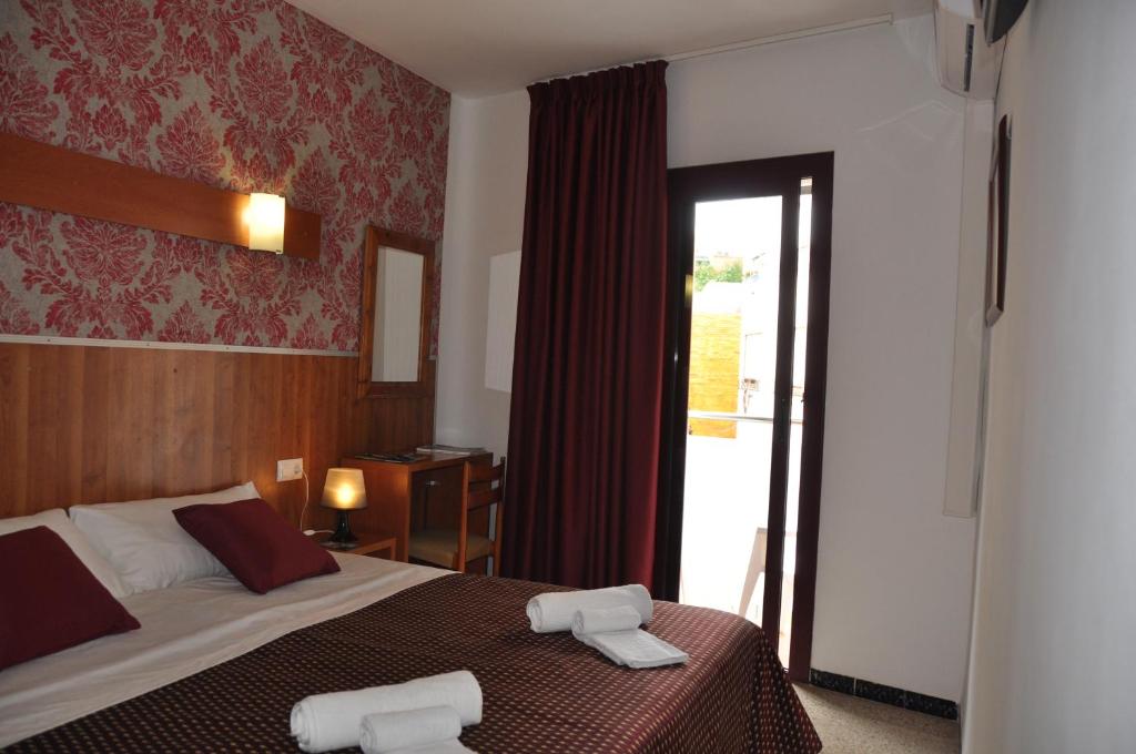 Postel nebo postele na pokoji v ubytování Hostal - Pensión El Amigo
