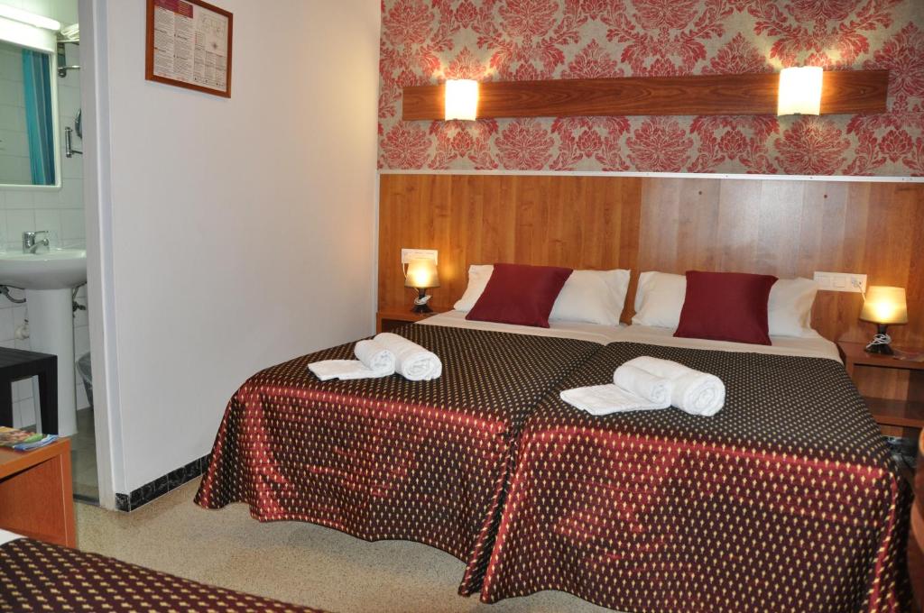 Postel nebo postele na pokoji v ubytování Hostal - Pensión El Amigo