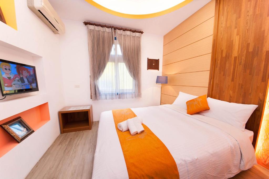 Postel nebo postele na pokoji v ubytování 墾丁南海旅店