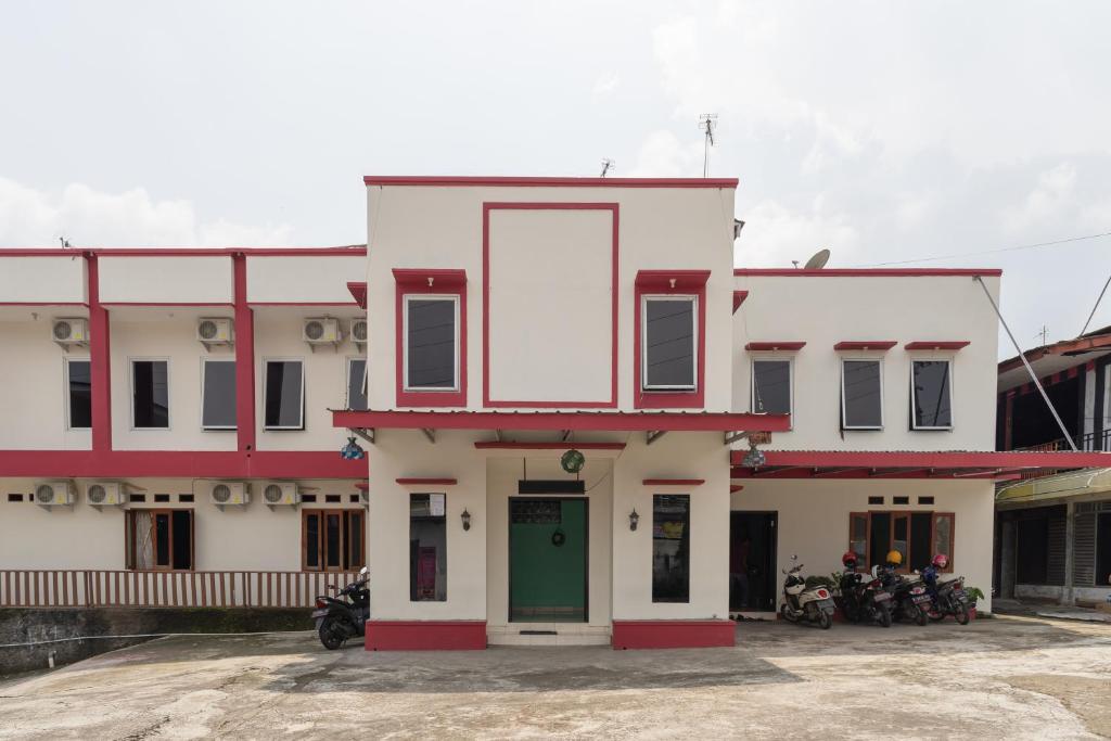 a building with motorcycles parked in front of it at RedDoorz @ Cibogo Puncak Bogor 2 in Bogor