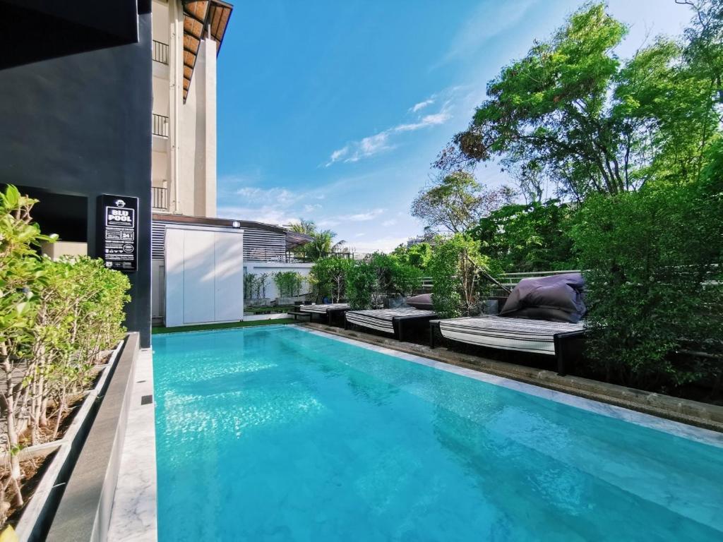a swimming pool in the backyard of a house at Blu Monkey Hub and Hotel Phuket Town- Free All Day Coworking space in Phuket Town