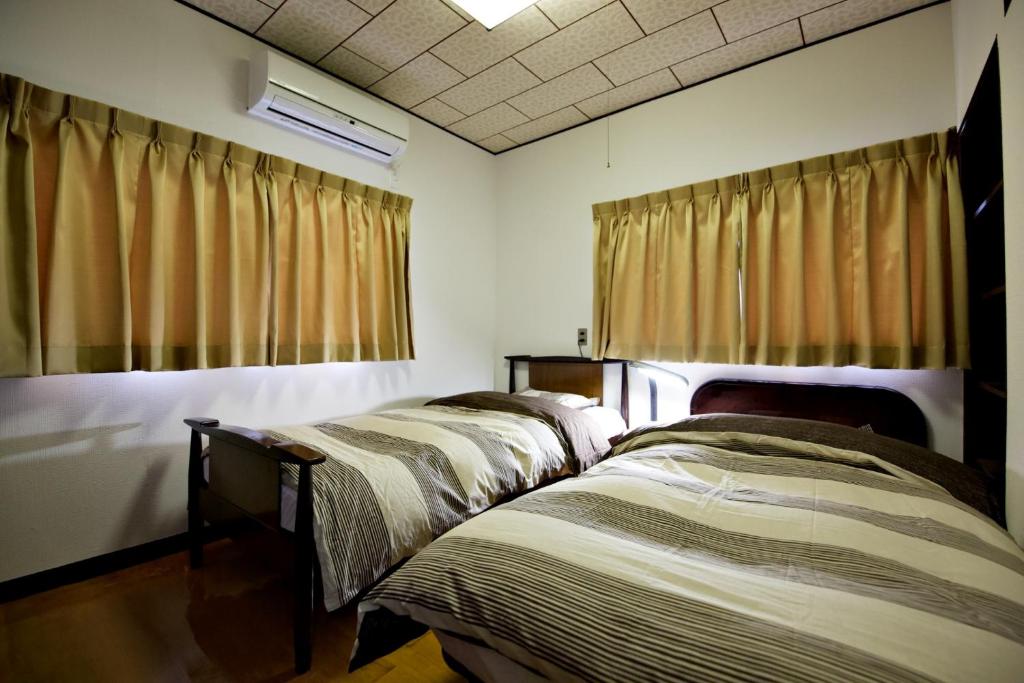 Postel nebo postele na pokoji v ubytování Gunma House