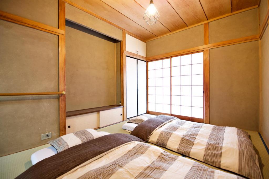 Postel nebo postele na pokoji v ubytování Gunma House