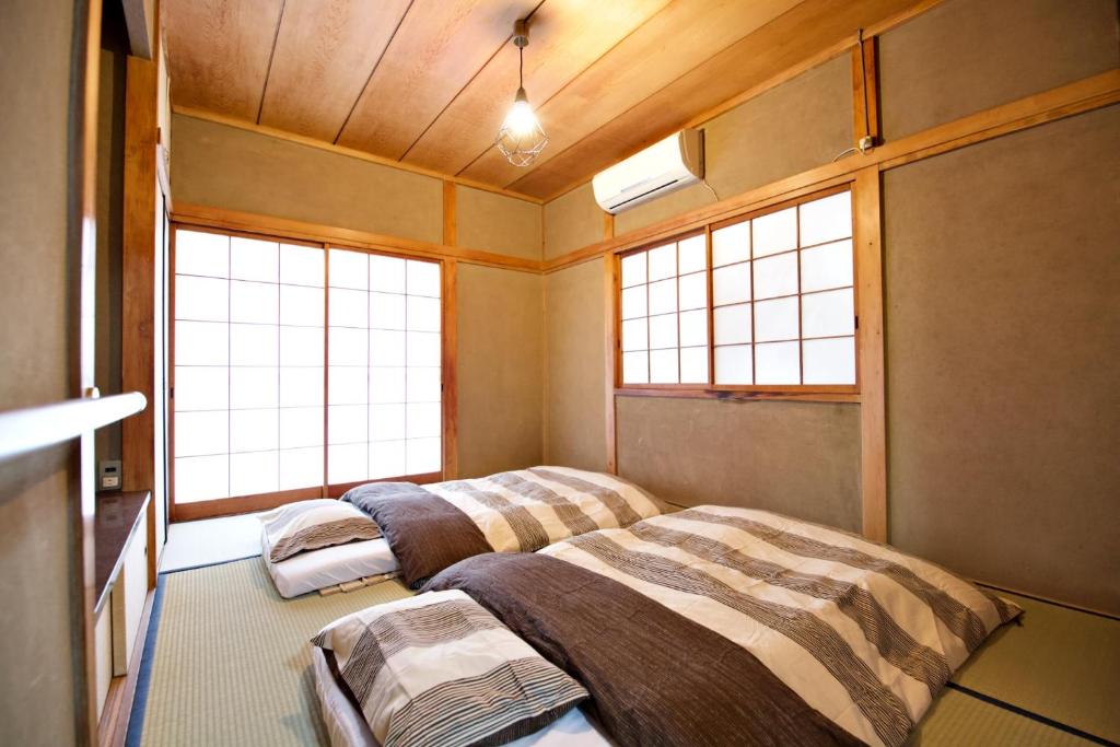 Postel nebo postele na pokoji v ubytování Gunma House